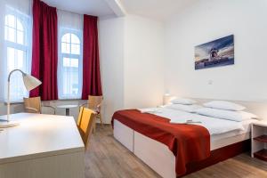 A bed or beds in a room at Apartmánový komplex Dagmar