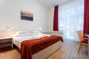 A bed or beds in a room at Apartmánový komplex Dagmar