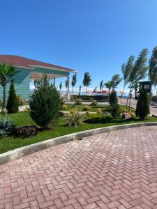 a brick driveway in front of a house with a beach at Таунхаус в Baytur Resort in Bosteri