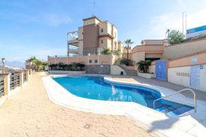 a swimming pool in front of a building at Tamango Hill Alcazaba B Casasol in Torrox