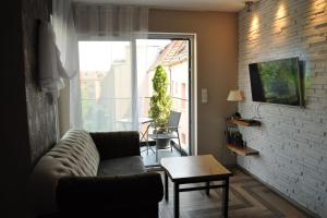 a living room with a couch and a table at Nowy apartament prime video in Opole