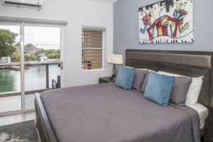 a bedroom with a bed with a view of the water at 246C, South Finger, Waterfront in Jolly Harbour