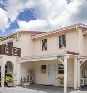 a large white house with a balcony at 246C, South Finger, Waterfront in Jolly Harbour