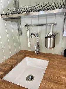 a kitchen sink with a faucet in a kitchen at Cosy Shepherds Hut Lyme Regis in Uplyme