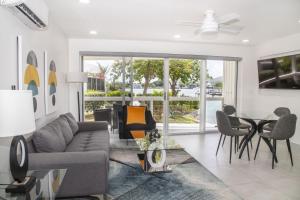 a living room with a couch and a table and chairs at 232A Lower Level, South Finger, Jolly Harbour in Jolly Harbour