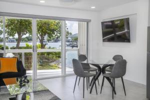 a dining room with a glass table and chairs at 232A Lower Level, South Finger, Jolly Harbour in Jolly Harbour