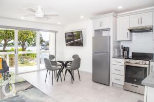 a kitchen with a table and chairs in a room at 232A Lower Level, South Finger, Jolly Harbour in Jolly Harbour