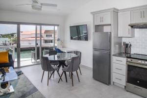 a kitchen with a table and chairs and a dining room at 232G Upper Level, South Finger in Jolly Harbour