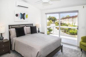 a bedroom with a bed and a large window at 232G Upper Level, South Finger in Jolly Harbour
