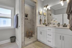 a white bathroom with a shower and a sink at Summer Coast House with hot tub and pool! in North Topsail Beach +84 photos