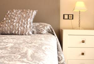 a bedroom with a bed with a pillow and a dresser at Denébola 112 by Sea You There Fuerteventura in Cotillo