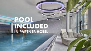 a hotel lobby with a swimming pool and a sign at Glanz & Glory Appartements Sölden in Sölden