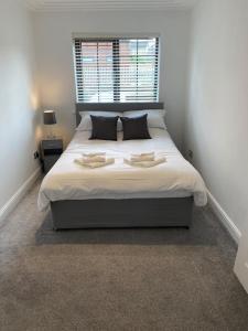 a bedroom with a large white bed with a window at Luxury 2 Bedroom Aparmant in Morley in Morley