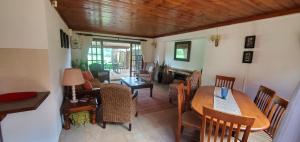 a living room with a table and chairs at Walkers Peak Cottage in Underberg