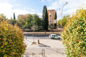 a white car parked in a parking lot at Piso junto a Parque de las Ciencias en Granada in Granada