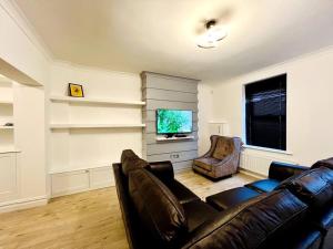a living room with a couch and a television at Modern 2-bed in Blyth centre in Blythe