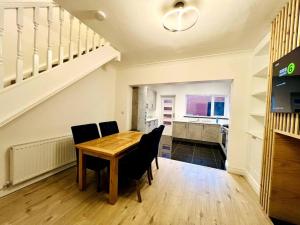 a dining room with a wooden table and chairs at Modern 2-bed in Blyth centre in Blythe