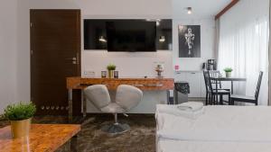 a living room with a couch and a table at VacationClub - Royal Tulip Sand Apartament 208 in Kołobrzeg