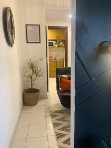 a hallway with a couch and a plant in a room at Beach apt w/ parking, 24/7 security, tennis court in Libreville