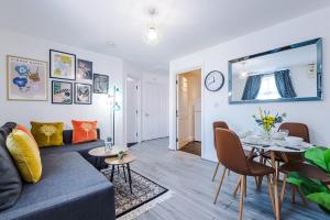 a living room with a couch and a table at The Davidson Serviced Apartment Coventry in Coventry