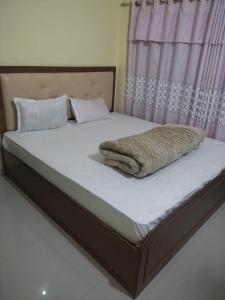a bed with a blanket on top of it at Hotel aradhya in Lumbini