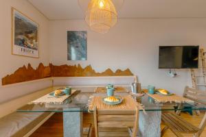 a dining room with a glass table and chairs at Chamonix Sud - Grepon 408 - Happy Rentals in Chamonix