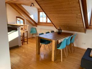 a kitchen and dining room with a wooden table and chairs at Annahof in Argenbühl