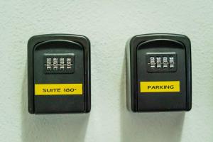 two black parking meters sitting next to each other at Suite 180° - Lago di Como in Blevio