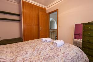 a bedroom with a bed with two towels on it at 042 - Las Marismas I - 002 comfortHOLIDAYS in Santa Pola