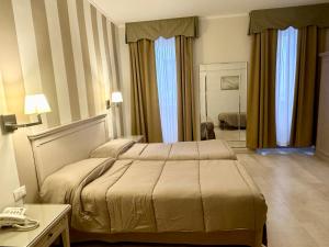 Postel nebo postele na pokoji v ubytování Hotel Bristol
