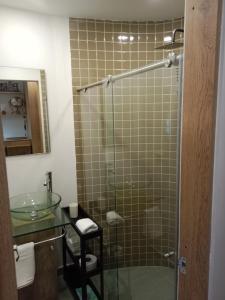 a bathroom with a glass shower with a sink at Soul Santa Bárbara executive, wifi 300 megas, Big Queen size bed, Smart tv Netflix, Walking distance to Unicentro Mall, Starbucks in front of the building, Top location in Bogotá
