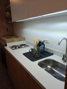 a kitchen counter top with a sink and a sink at Soul Santa Bárbara executive, wifi 300 megas, Big Queen size bed, Smart tv Netflix, Walking distance to Unicentro Mall, Starbucks in front of the building, Top location in Bogotá