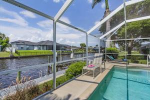 an image of a house with a swimming pool at Serene canal, three bedrooms and a large pool! - Villa La Brisa Fresca in Cape Coral