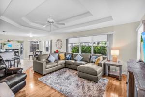 a living room with a couch and a table at Serene canal, three bedrooms and a large pool! - Villa La Brisa Fresca in Cape Coral