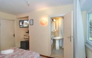 a bedroom with a bathroom with a sink and a toilet at Storyville Simple Stay in Cinquale