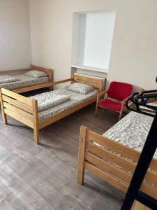 a room with three bunk beds and a red chair at Apartment in Kovelʼ