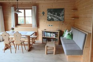 a living room with a table and a couch at Unterplattnerhof in Chiusa