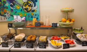 a buffet with different types of food on a table at Hotel Director Vitacura in Santiago