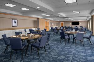 a conference room with tables and chairs and a screen at Courtyard by Marriott Phoenix West/Avondale in Phoenix