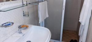 a bathroom with a white sink and a shower at Stay with low budget in Marrakesh +11 photos