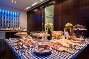 a buffet of food on a blue and white checked table cloth at Sixtytwo Hotel in Barcelona