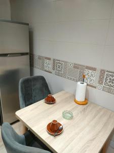 a table in a kitchen with two chairs and a table at les temps heureux in Alger