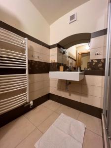 a bathroom with a sink and a mirror at Penzion Stanský Mlýn in Hlinsko