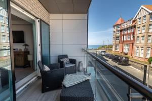 a balcony with chairs and a view of a street at 31 Cliff Edge in Newquay