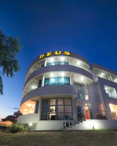 a large building with a sign on top of it at Apartments Deus in Dobra Voda