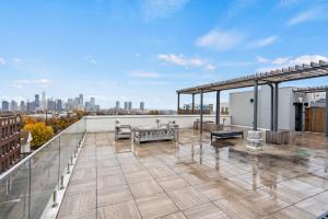 a rooftop deck with a view of the city at Stylish & Chic Experience in JC in Jersey City