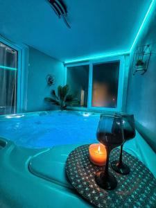 a blue room with a tub with a candle in it at Luxor - Jacuzzi&Cozy Apartments in Sibiu