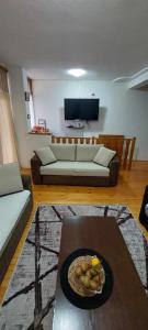 a living room with a couch and a table at Apartman u Kuci u Konjicu in Konjic