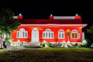 a red house with people sitting in front of it at Duroyo hotel in Gilgit +102 photos