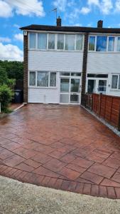 a house with a brick patio in front of it at Flourish House in Kent